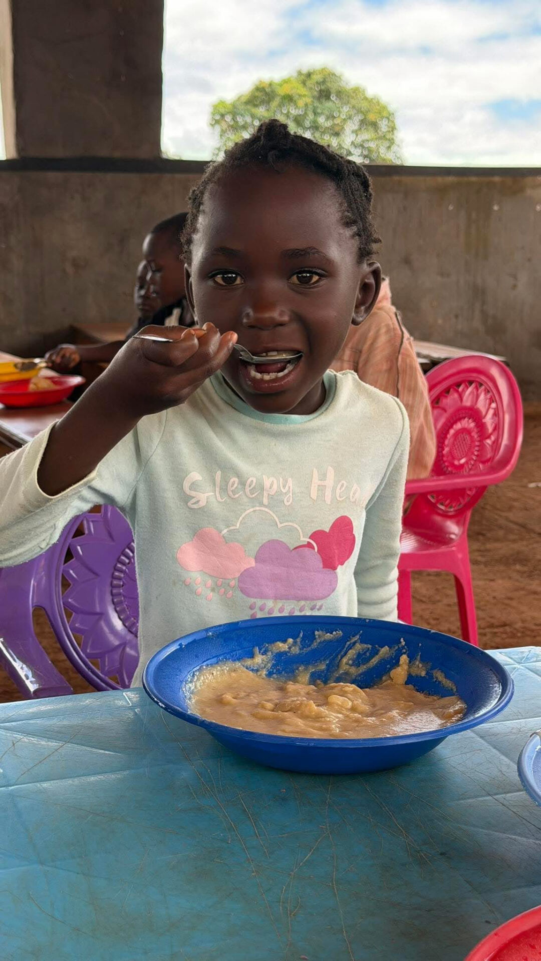A Blessed Land Academy pupil eating a school-day meal
