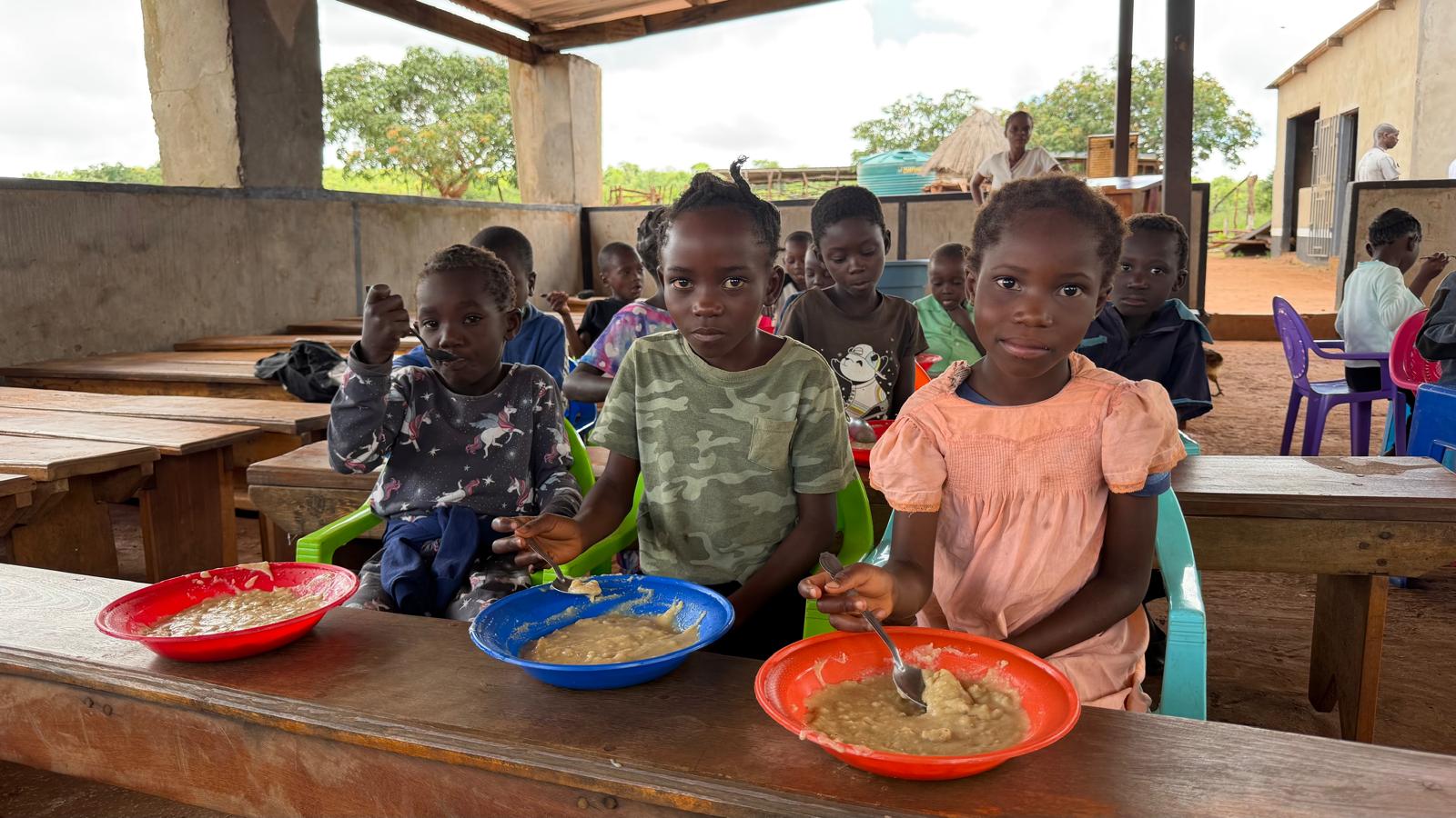 Children at Blessed Land Academy eating a daily school meal
